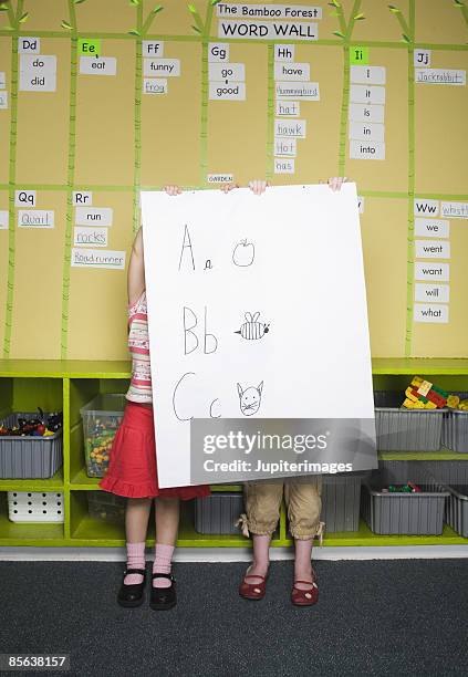 girls behind posterboard - cat holding sign stock pictures, royalty-free photos & images