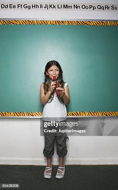 girl playing recorder - recorder foto e immagini stock