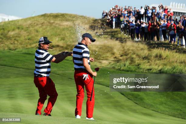 Charlie Hoffman sprays Daniel Berger of the U.S. Team with champagne after Berger defeated Si Woo Kim of South Korea and the International Team on...