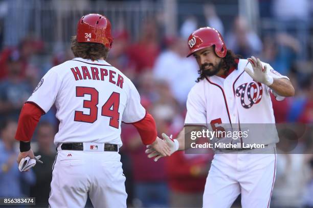 Anthony Rendon of the Washington Nationals celebrates hitting a three run home run in the first inning with Bryce Harper during a baseball game...