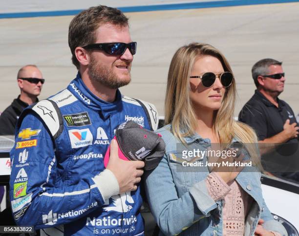 Dale Earnhardt Jr., driver of the Nationwide Chevrolet, and his wife Amy, stand on the grid during the National Anthem prior to the Monster Energy...
