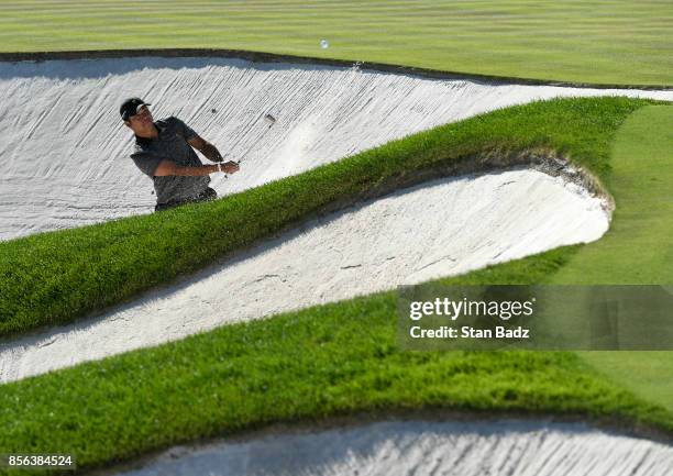 Si Woo Kim of South Korea and the International Team plays his shot out of the bunker during the Sunday singles matches at the Presidents Cup at...