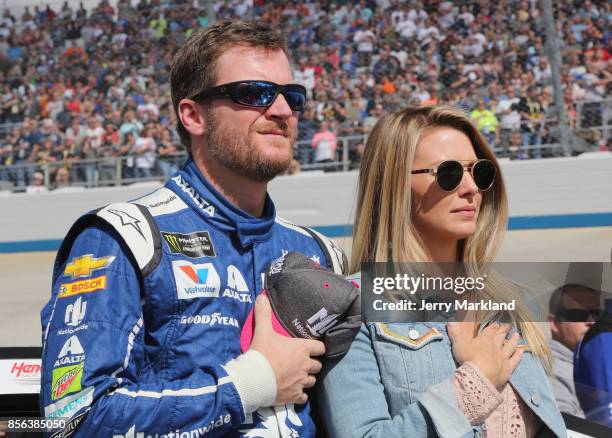 Dale Earnhardt Jr., driver of the Nationwide Chevrolet, and his wife Amy, stand on the grid during the National Anthem prior to the Monster Energy...