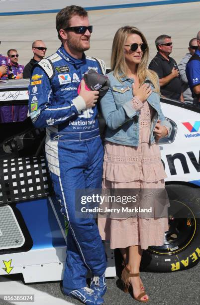 Dale Earnhardt Jr., driver of the Nationwide Chevrolet, and his wife Amy, stand on the grid during the National Anthem prior to the Monster Energy...