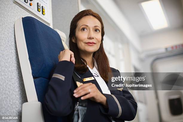 stewardess preparing for take off on airplane - tripulación oficio de transporte fotografías e imágenes de stock