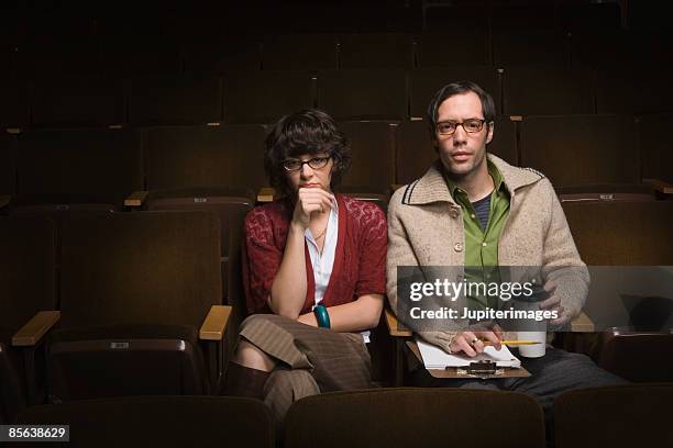 casting directors sitting in theater - criticus stock pictures, royalty-free photos & images