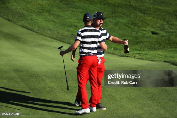 Charlie Hoffman celebrates with Daniel Berger of the U.S. Team after Berger defeated Si Woo Kim of South Korea and the International Team on the 17th...