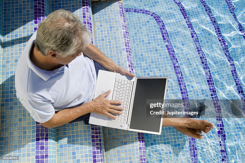 Man Sitting In Swimming Pool With Laptop Computer High-Res Stock Photo ...