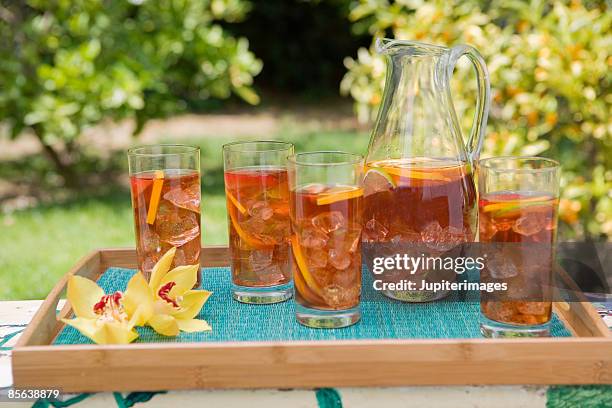 pitcher and glasses of fruit iced tea - ice tea stock pictures, royalty-free photos & images