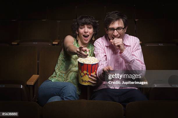 couple laughing in movie theatre - auditoria bildbanksfoton och bilder