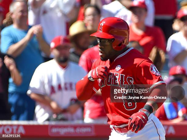 Eric Young Jr. #8 of the Los Angeles Angels of Anaheim crosses the plate after hitting a three run home run in the seventh inning of the game against...