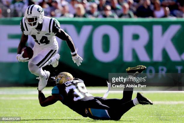 Jeremy Kerley of the New York Jets jumps over Tashaun Gipson of the Jacksonville Jaguars in the second half during their game at MetLife Stadium on...