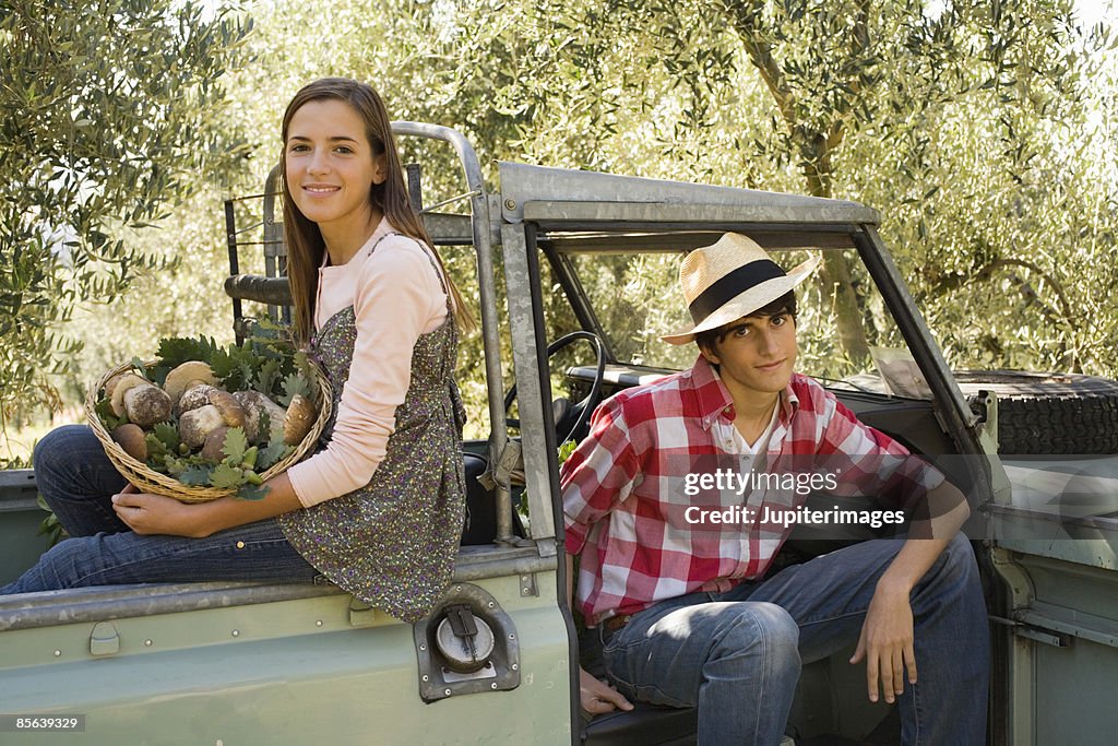 Teenagers with harvested porcini mushrooms , Italy