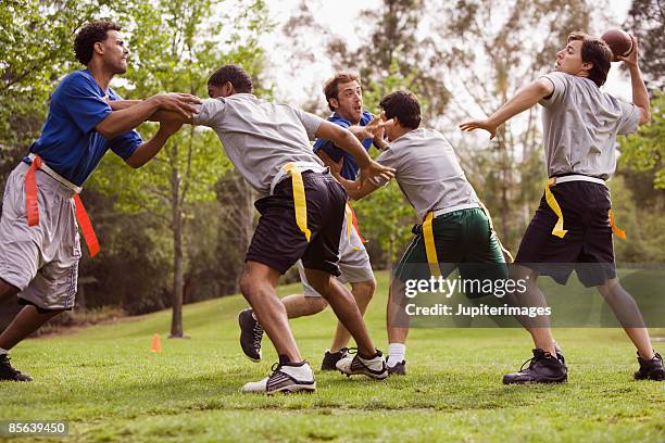 men playing flag football - kinder football stock-fotos und bilder