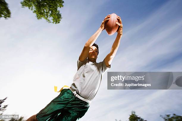 man catching football - flag football stock pictures, royalty-free photos & images