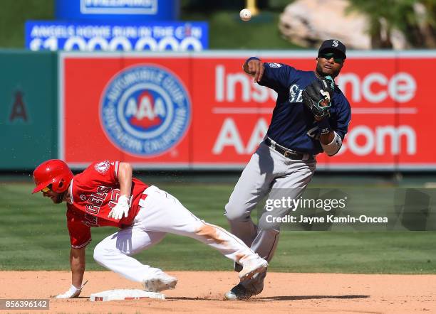 Shane Robinson of the Los Angeles Angels of Anaheim is safe at second as Robinson Cano of the Seattle Mariners throws to first but is unable to make...