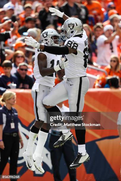 Wide receiver Johnny Holton and tight end Clive Walford of the Oakland Raiders celebrate after a Holton touchdown in the second quarter of a game at...