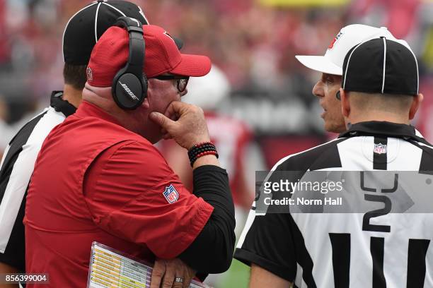 Head coach Bruce Arians of the Arizona Cardinals talks with referee Tony Corrente and line judge Bart Longson during the first half of the NFL game...