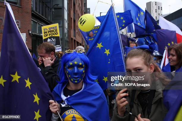 An Anti-Brexit demonstrator wears a European Union Star mask during Conservative Party protests that greeted delegates to the Tories Autumn...