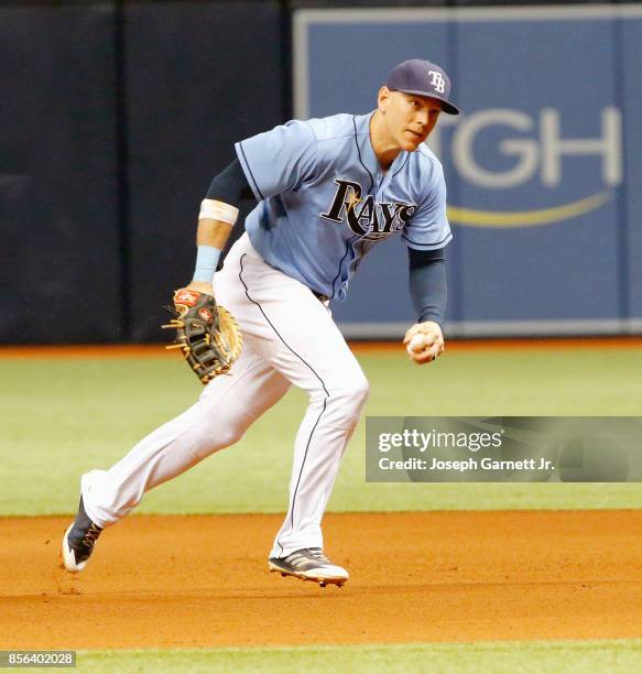 Trevor Plouffe of the Tampa Bay Rays looks to throw after fielding a ground ball during the seventh inning against the Baltimore Orioles at Tropicana...