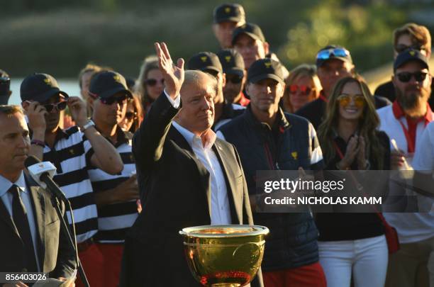 President Donald Trump participates in the trophy presentation of the Presidents Cup golf championship at Liberty National Golf Club in Jersey City,...