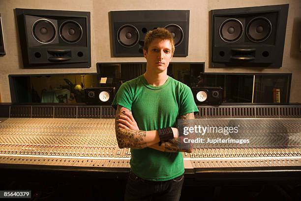 man with arms crossed in recording studio - performer stock photos et images de collection