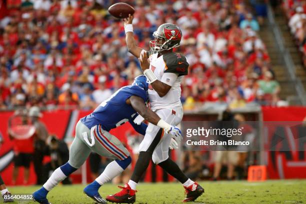 Quarterback Jameis Winston of the Tampa Bay Buccaneers is hit by strong safety Landon Collins of the New York Giants as he realize the ball during...