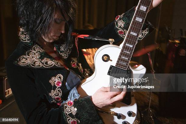 man playing guitar - glam rock stock pictures, royalty-free photos & images
