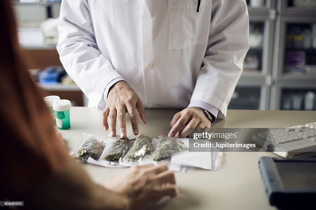 Pharmacist and customer with medical marijuana