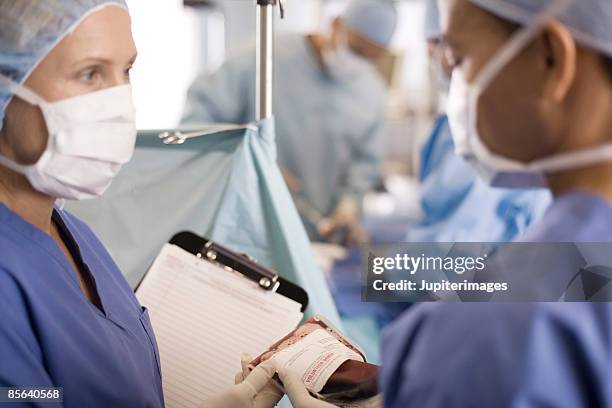 doctors in operating room with bag of blood - blood bag stock pictures, royalty-free photos & images