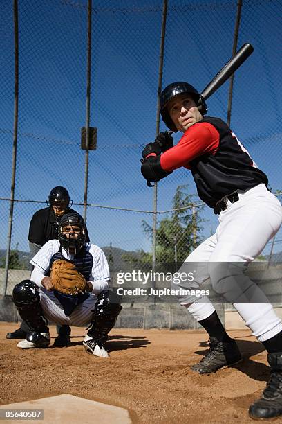 baseball player holding baseball bat - backstop foto e immagini stock