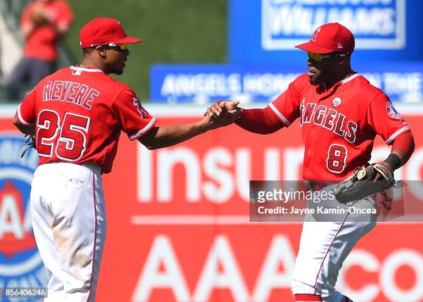 Eric Young Jr. #8 and Ben Revere of the Los Angeles Angels of Anaheim shake hands after the final out of the game Seattle Mariners at Angel Stadium...