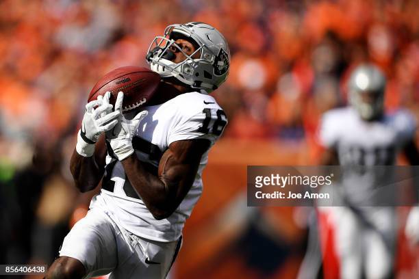 Johnny Holton of the Oakland Raiders hauls in a 64-yard touchdown reception against the Denver Broncos during the second quarter on Sunday, October...