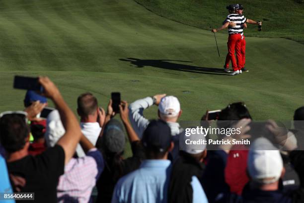 Charlie Hoffman and Daniel Berger of the U.S. Team celebrate after Berger defeated Si Woo Kim of South Korea and the International Team on the 17th...