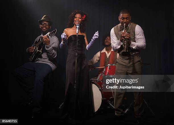 singer performing with band in nightclub - jazz musician stock pictures, royalty-free photos & images