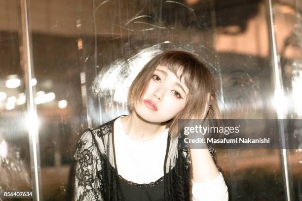 portrait of contemporary japanese young woman on the night street - ボブヘア ストックフォトと画像