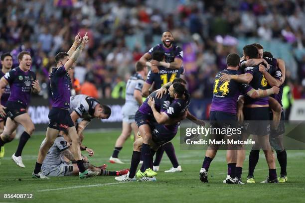 Storm players celebrate victory in the 2017 NRL Grand Final match between the Melbourne Storm and the North Queensland Cowboys at ANZ Stadium on...