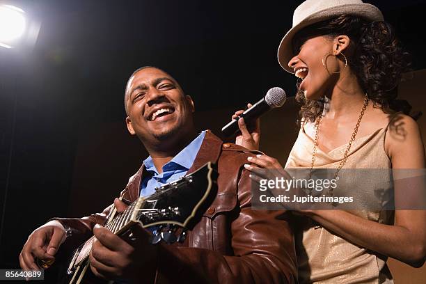 guitar player and singer performing jazz in nightclub - black guitarist stock pictures, royalty-free photos & images