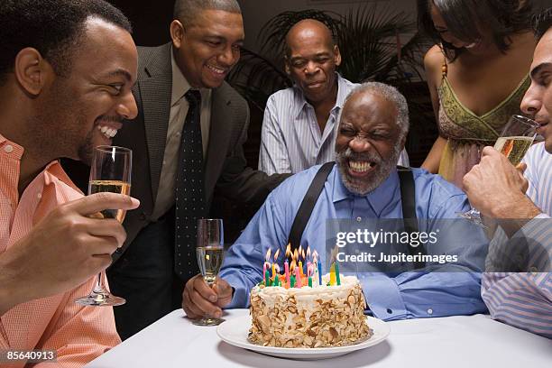 man celebrating birthday with friends at fancy restaurant - cake party stock pictures, royalty-free photos & images