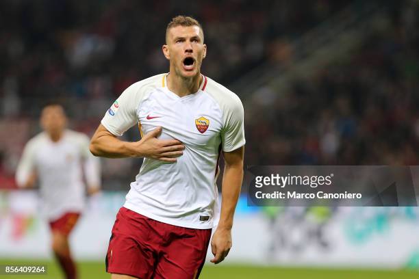 Edin Dzeko of As Roma celebrate after scoring first goal during the Serie A football match between AC Milan and As Roma . As Roma wins 2-0 over Ac...