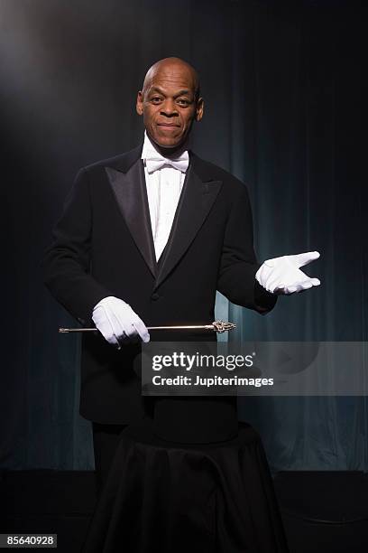 magician performing on stage - magician stock pictures, royalty-free photos & images