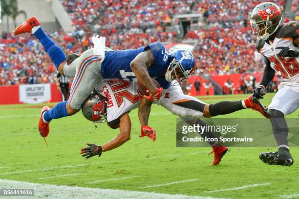 New York Giants wide receiver Brandon Marshall is brought down by Tampa Bay Buccaneers cornerback Brent Grimes after a reception during an NFL...