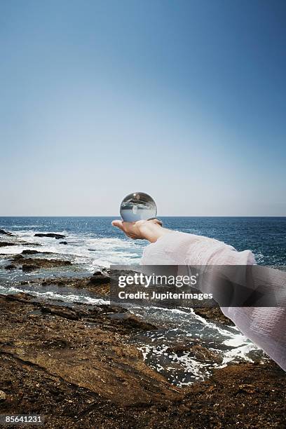 woman's hand with glass ball - world philosophy day stock pictures, royalty-free photos & images