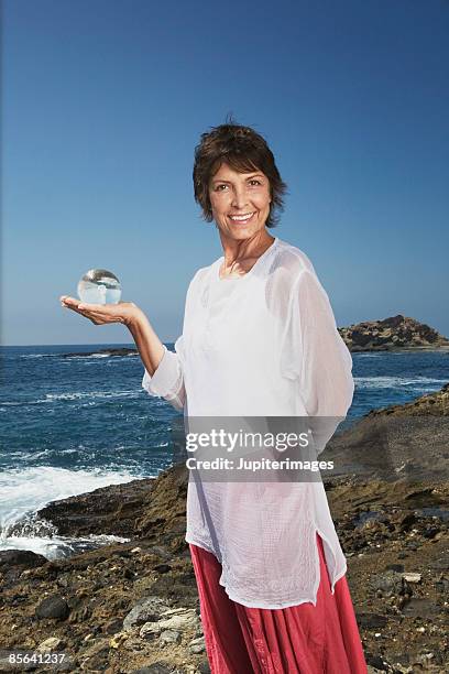 smiling woman holding glass ball - world philosophy day photos et images de collection