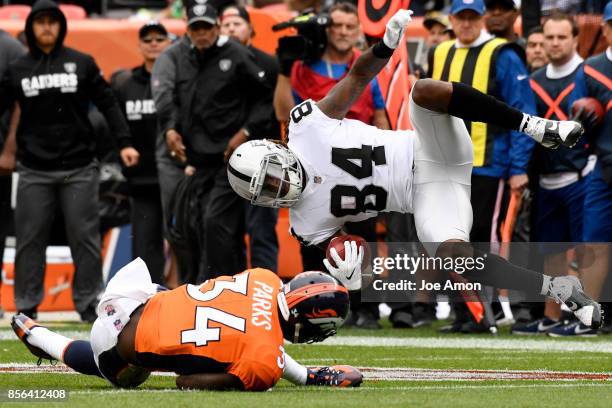 Will Parks of the Denver Broncos upends Cordarrelle Patterson of the Oakland Raiders during the third quarter on Sunday, October 1, 2017. The Denver...