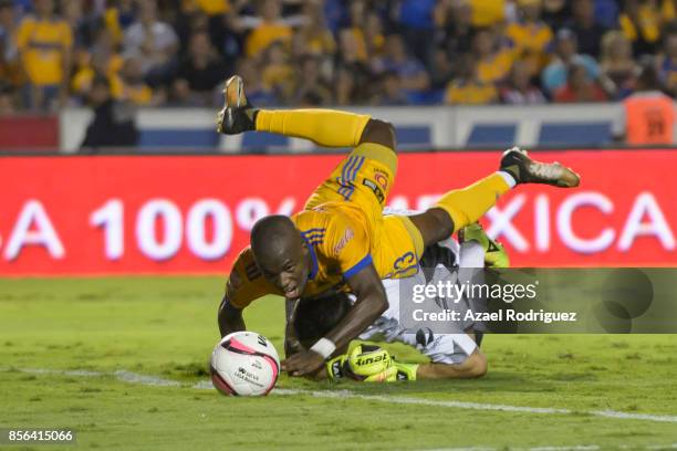 Enner Valencia of Tigres crashes with Rodolfo Cota, goalkeeper of Chivas during the 12th round match between Tigres UANL and Chivas as part of the...