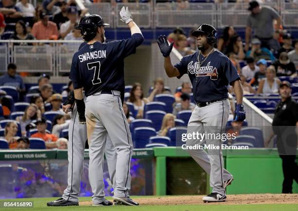 Adonis Garcia of the Atlanta Braves is congratulated after hitting a three run home run in the seventh inning during a game against the Miami Marlins...