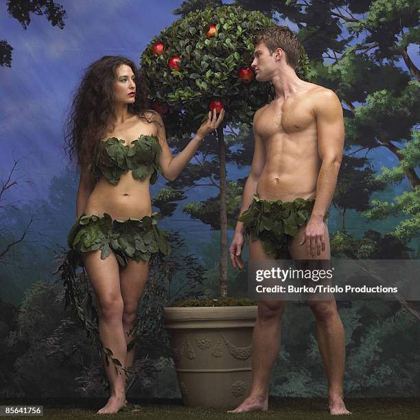 adam and eve with apple tree in garden of eden - passion fruit photos et images de collection