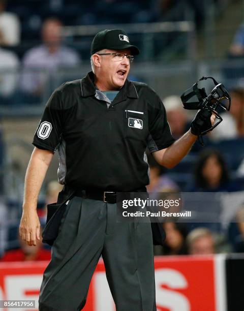 Umpire Paul Emmel shouts towards Manny Machado of the Baltimore Orioles as Machado questioned a call in an MLB baseball game against the New York...