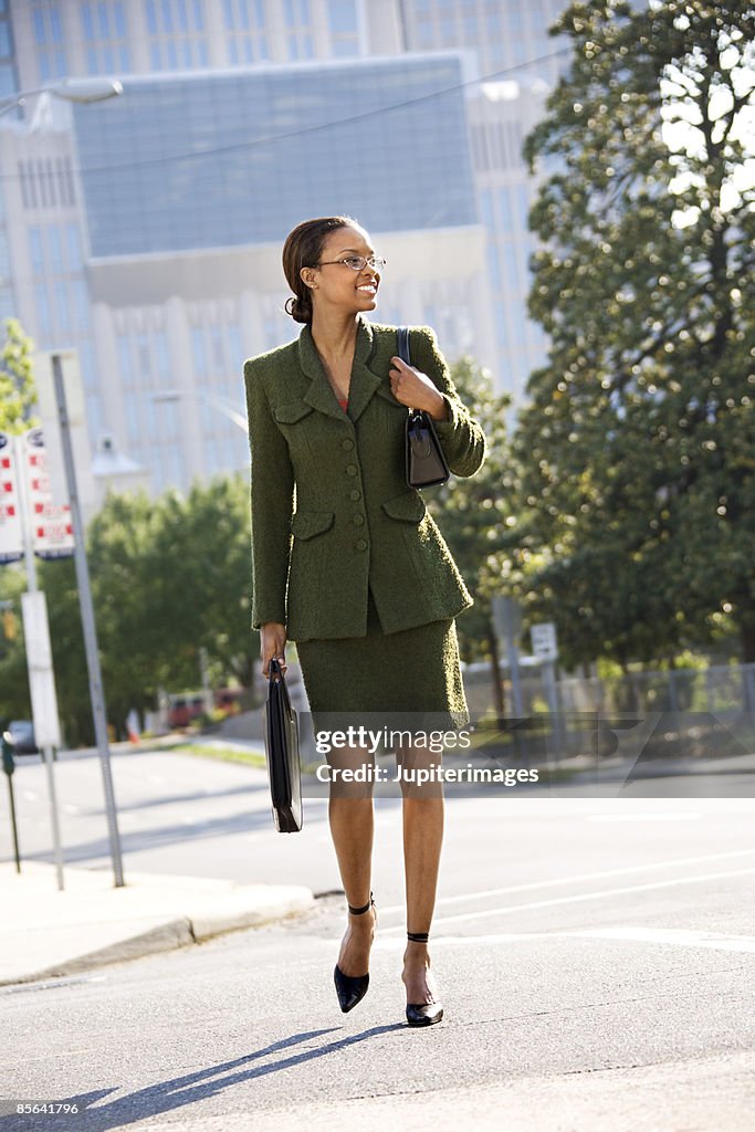 Businesswoman crossing street